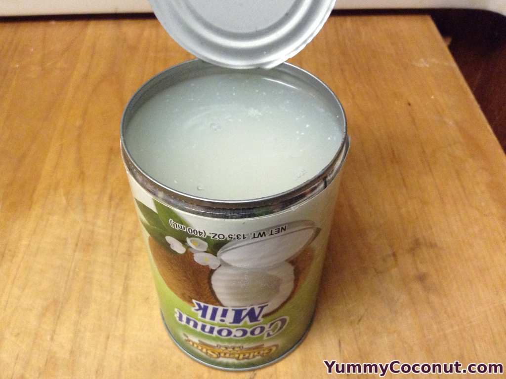 coconut cream in can opened with liquid on top